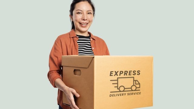 Woman carrying a moving box